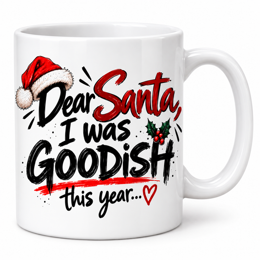 unny Dear Santa I Was Goodish Christmas mug in white ceramic with festive red and black lettering and a Santa hat.