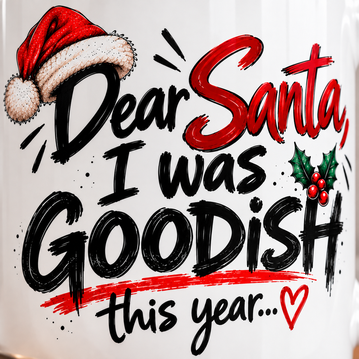 Close-up of Dear Santa I Was Goodish Christmas mug featuring bold festive lettering, Santa hat, holly berries and red heart.