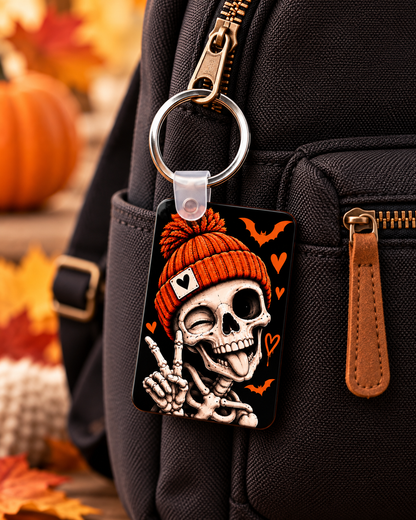 Orange beanie skeleton keychain attached to a bag for Halloween accessory styling